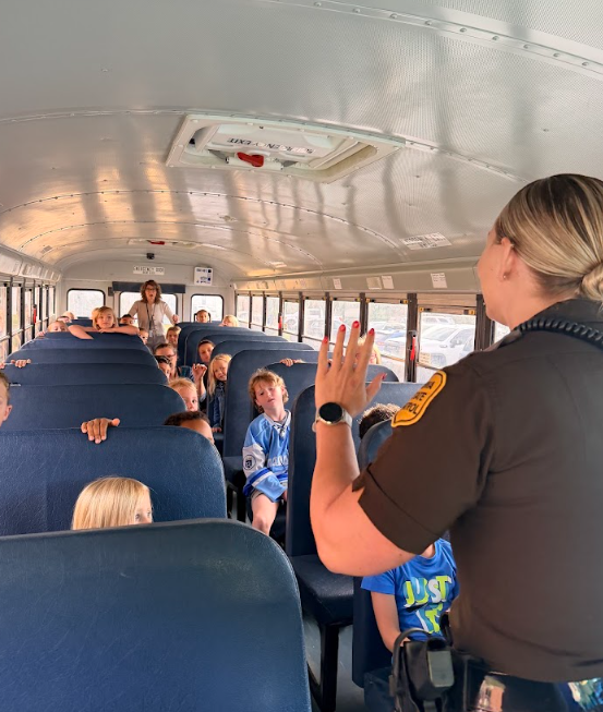 Bus Evac Drill Trooper speaking with bus load of students