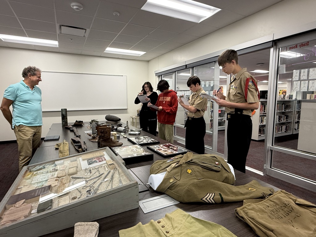 Mrs. Kathy Burns’ and Ms. Susan Sharps’ classes participated in a powerful Gallery Walk after reading Night by Elie Wiesel, exploring WWII and the Holocaust through artifacts, images, videos, music, and artwork.  A special thank-you to Mr. Jim Eccleston for sharing his collection, hosting a station, and taking student questions, and to Mrs. Wrenn Kibler and Mrs. Jessica North for hosting the event in the Library Media Center and helping make this meaningful learning experience possible.