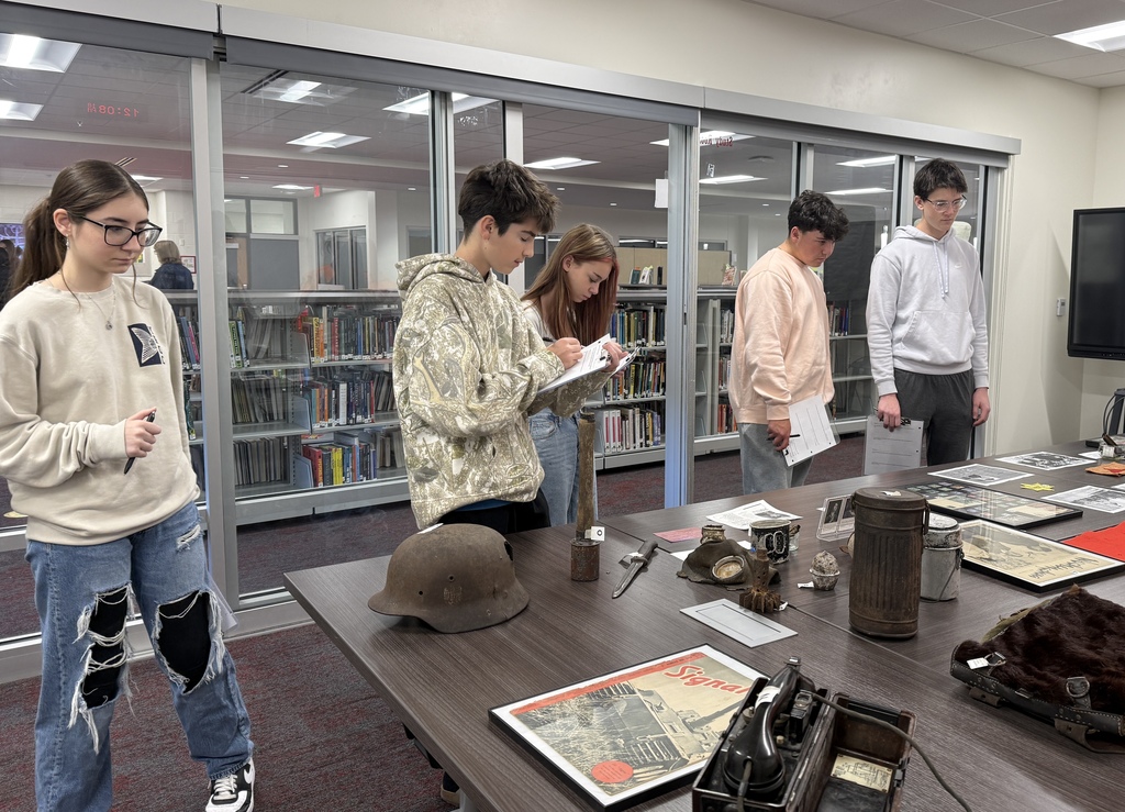 Mrs. Kathy Burns’ and Ms. Susan Sharps’ classes participated in a powerful Gallery Walk after reading Night by Elie Wiesel, exploring WWII and the Holocaust through artifacts, images, videos, music, and artwork.  A special thank-you to Mr. Jim Eccleston for sharing his collection, hosting a station, and taking student questions, and to Mrs. Wrenn Kibler and Mrs. Jessica North for hosting the event in the Library Media Center and helping make this meaningful learning experience possible.
