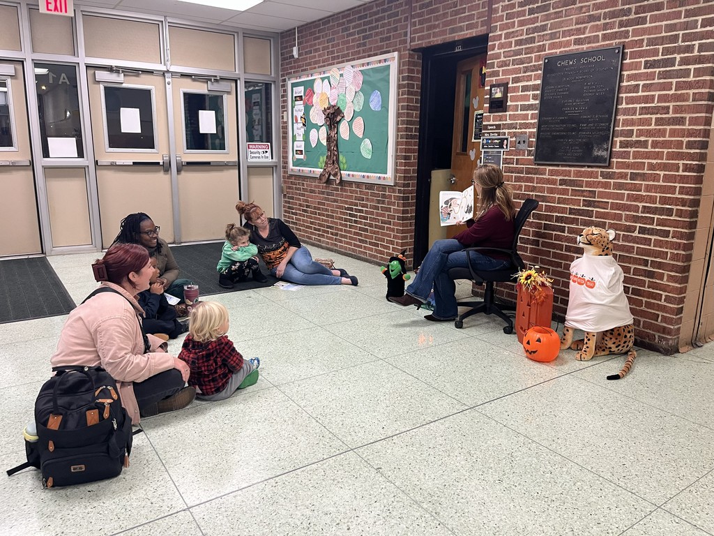 Students and Parents listening to a story at Champ's Reading Patch