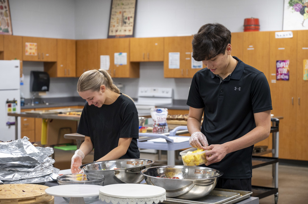 Students cleaning up dishes in the kitchen area of their culinary classroom at Eisenhower High School