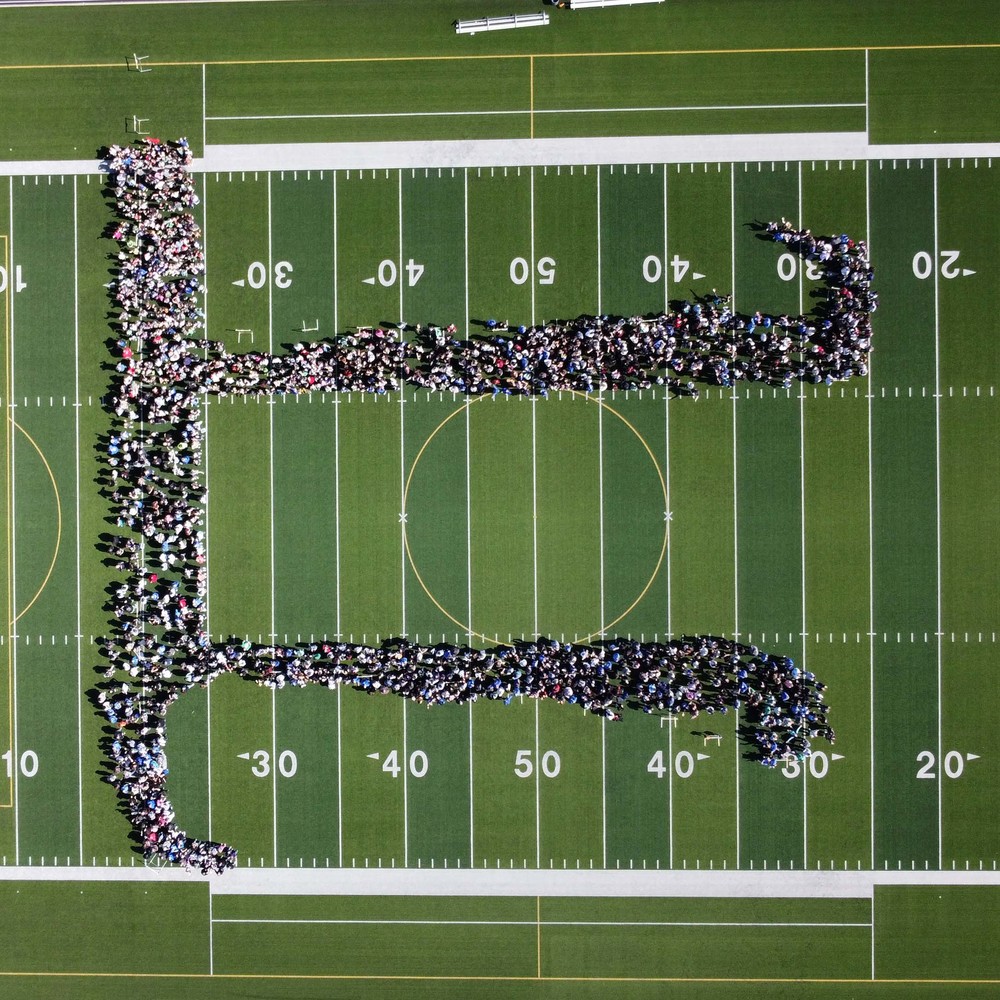 Areal view of the Human Pi Symbol formed by students, staff, and community at GHS.
