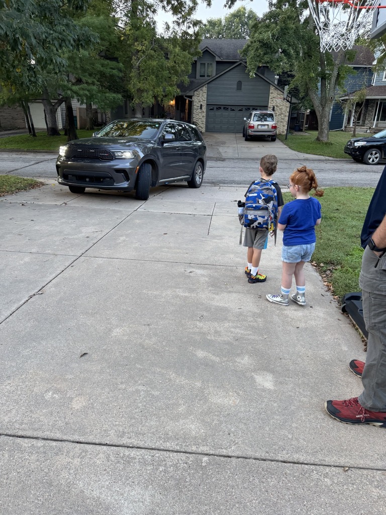 students waiting for a special ride in a cop car