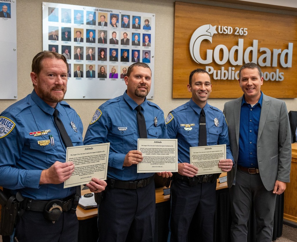 (from left to right) Officers Wyatt Pulver, Justin Malcom, and Ryan Lamar receive the District Attitude Award at the November 2025 USD 265 Board of Education meeting