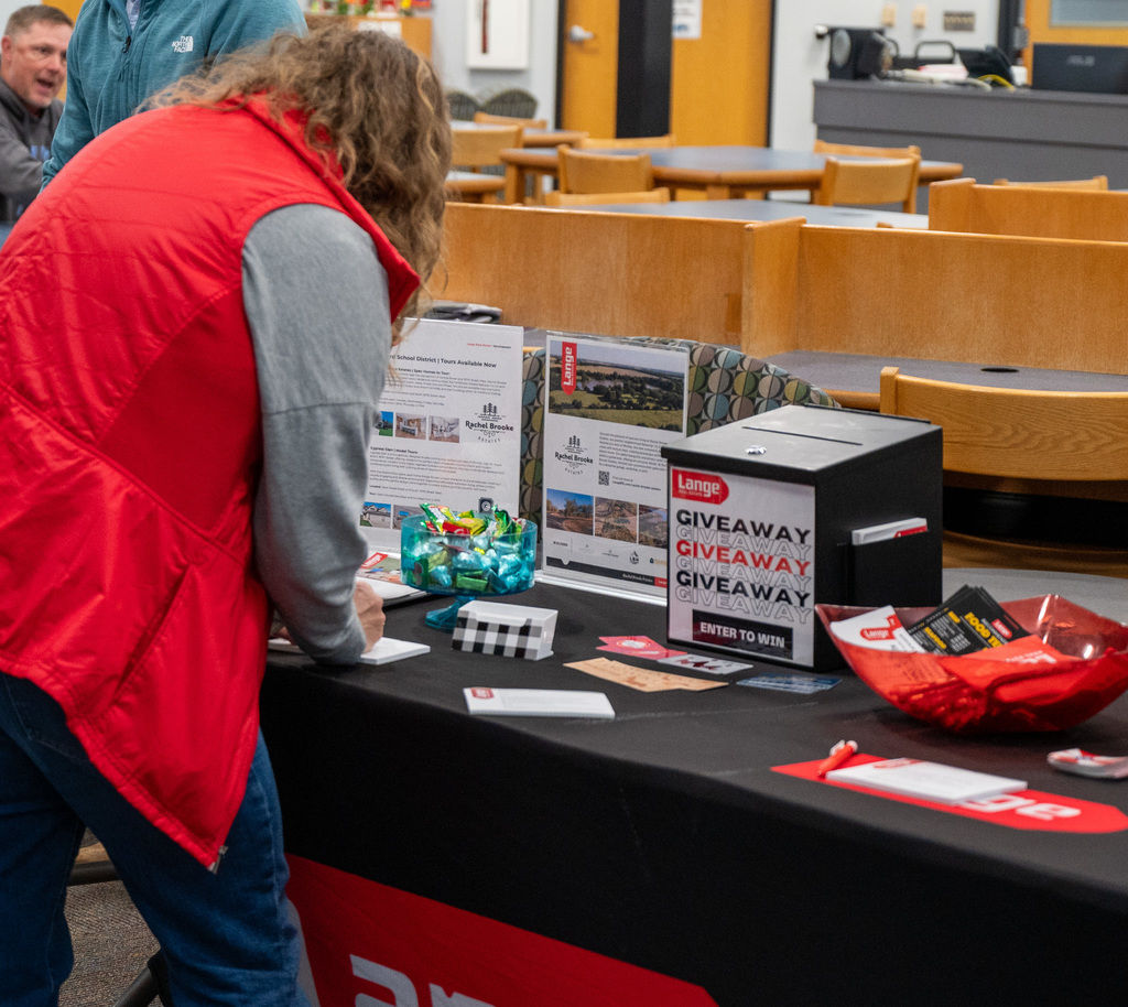 USD 265 staff member signs up for Lange Real Estate giveaway during a Goddard Education Foundation staff appreciation breakfast