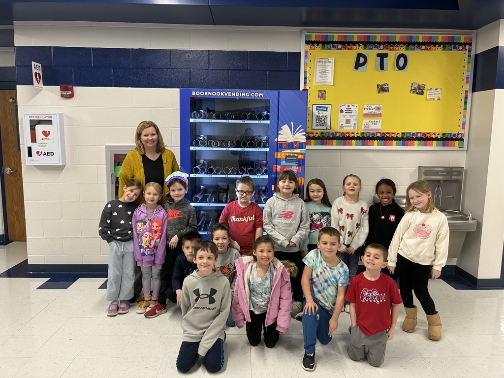 Students posting in front of Earharts new book nook vending machine!