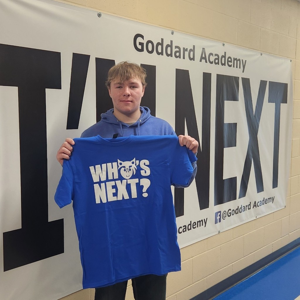 holding "who's next" shirt with "Im next" banner. 