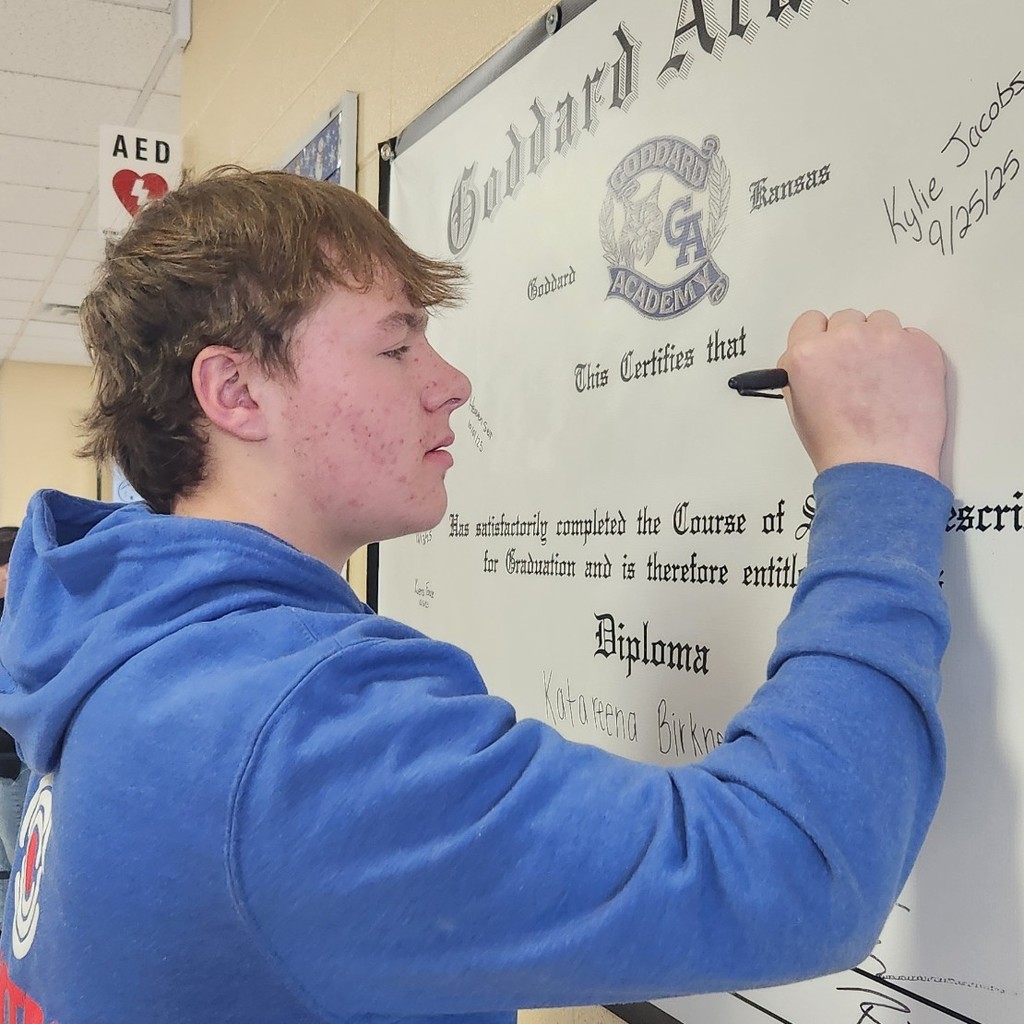 Braydon Helmers signing diploma