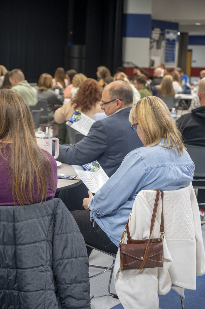 Attendees of the 2026 State of the District event reading the 2026 USD 265 Legislative Platform