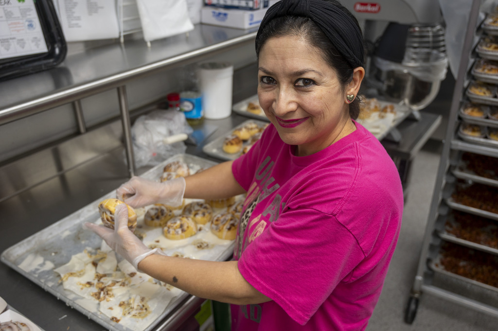 Member of the Nutrition Services team prepares dinner for attendees of the event