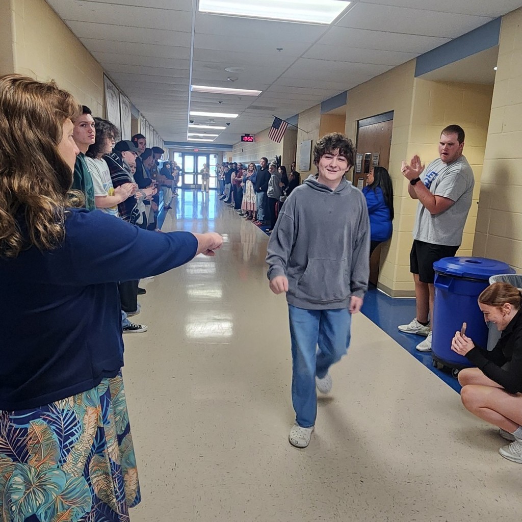 Eli walking down hallway