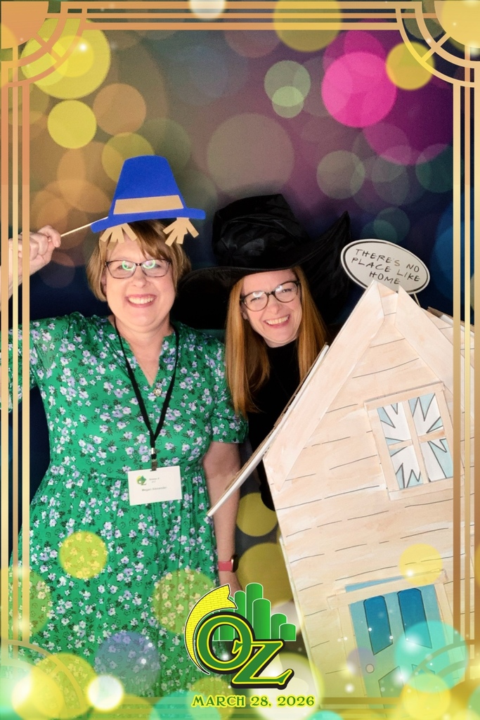 Two women dressed in vibrant costumes stand side by side, smiling for a photo, highlighting their creative attire.