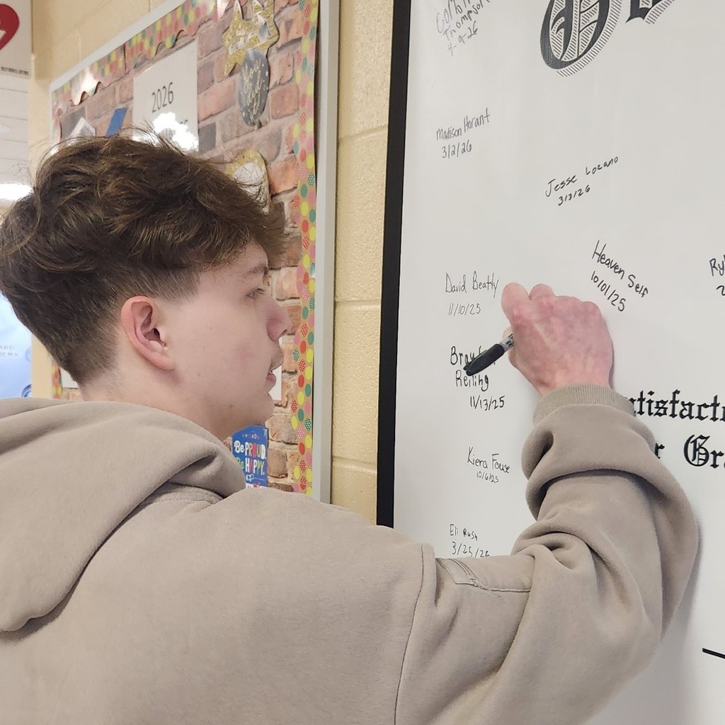 Riley Stefan signing diploma