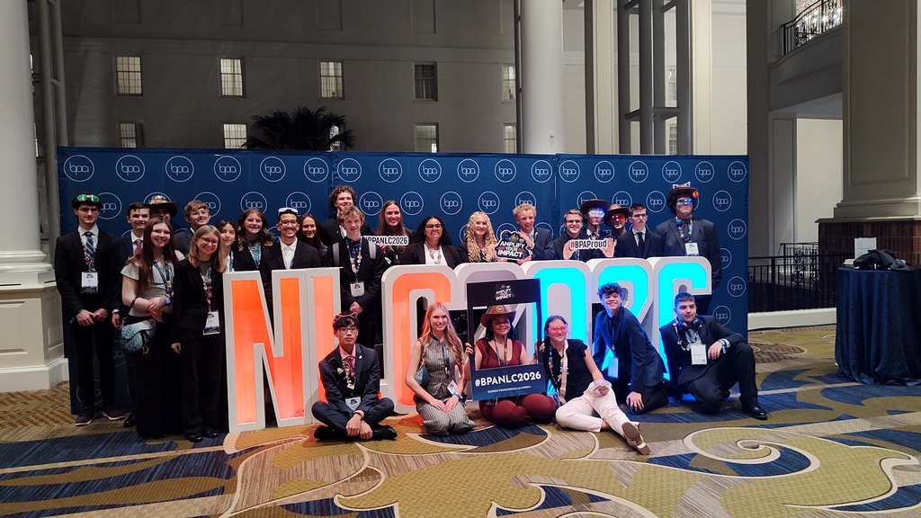 background:  inside of building entryway with a blue screen background, neon letters BPA 2026, IKE students  Text:  National Conference
