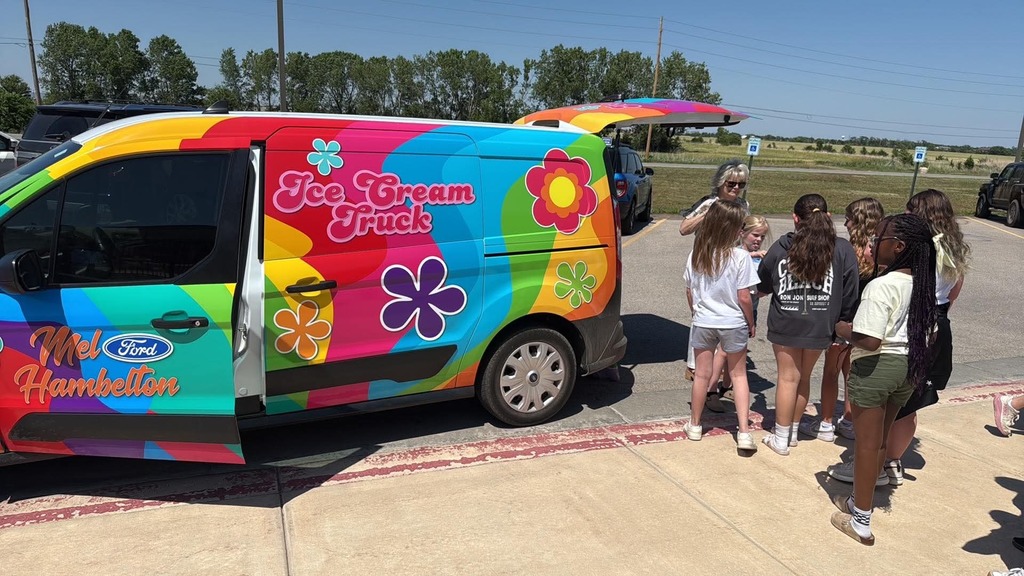 A colorful ice cream truck with floral patterns is parked on a sunny day. A group of smiling kids eagerly lines up nearby. The mood is joyful and lively.