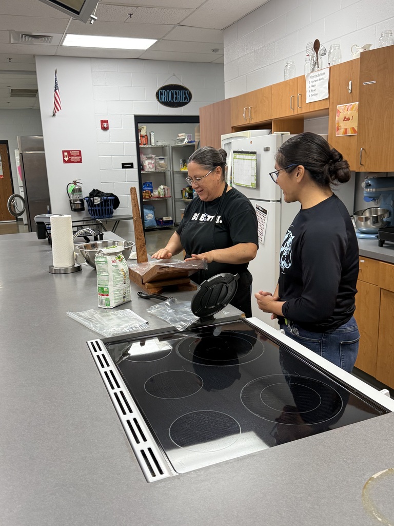 background:  culinary classroom with 2 kitchen ladies demonstrating at the counter