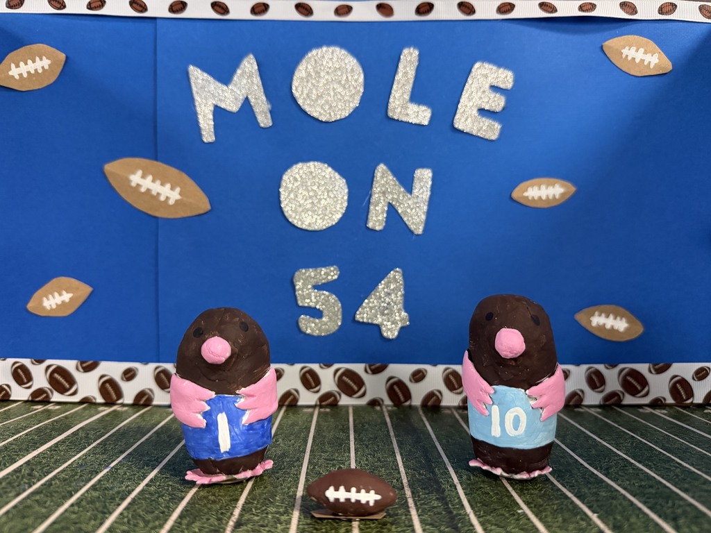background:  blue with footballs all over and football field with constructed moles in blue & light blue uniforms;  text:  mole on 54