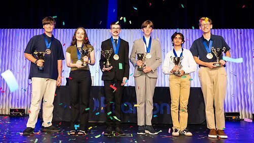 background: stage with purple curtain, confetti, and the microsoft student winners