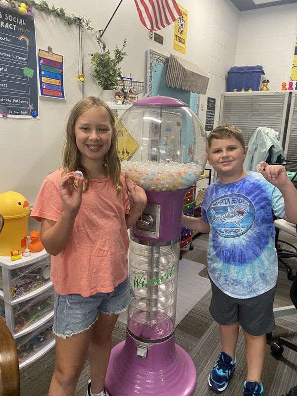 Kids holding up a gumball