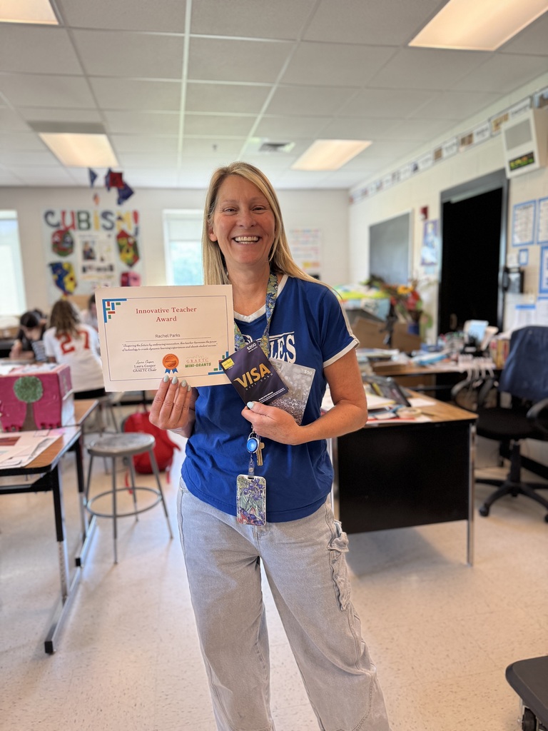 Ms. Parks holding the innovative teacher award and smiling