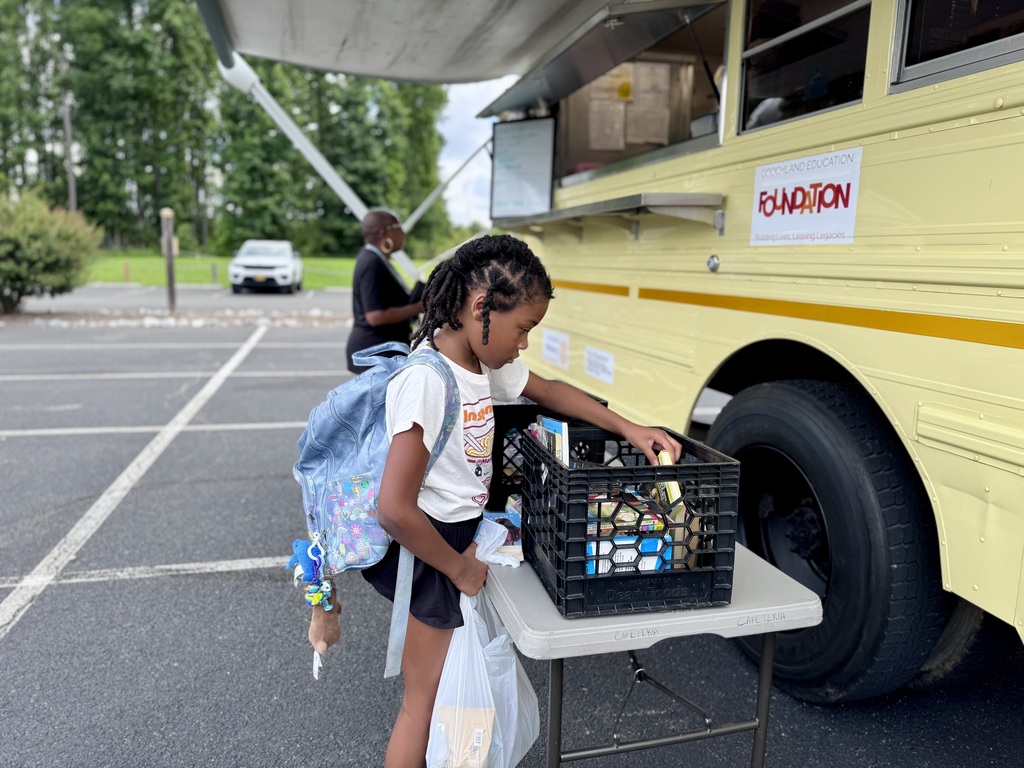 Student looking through a bin of free books