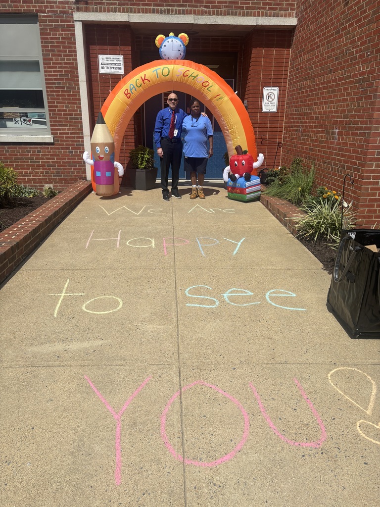 Mr. Meiller and Ms. Smith welcoming families back to school.