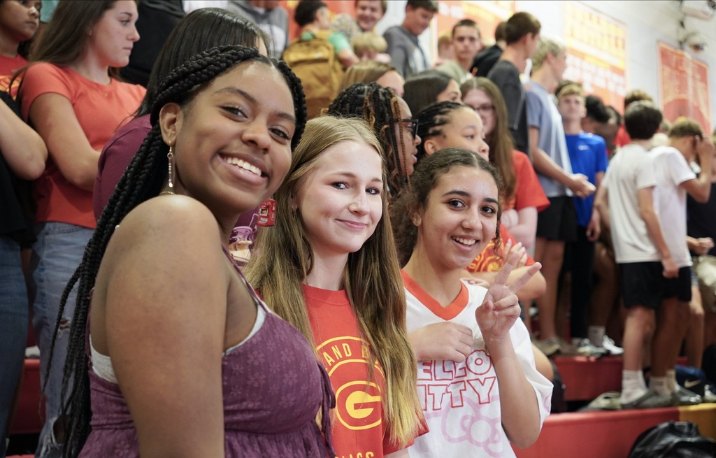 Three students posing for picture during pep rally