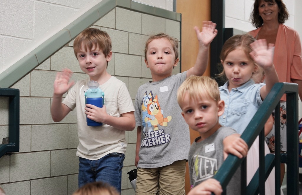 Preschool students waving