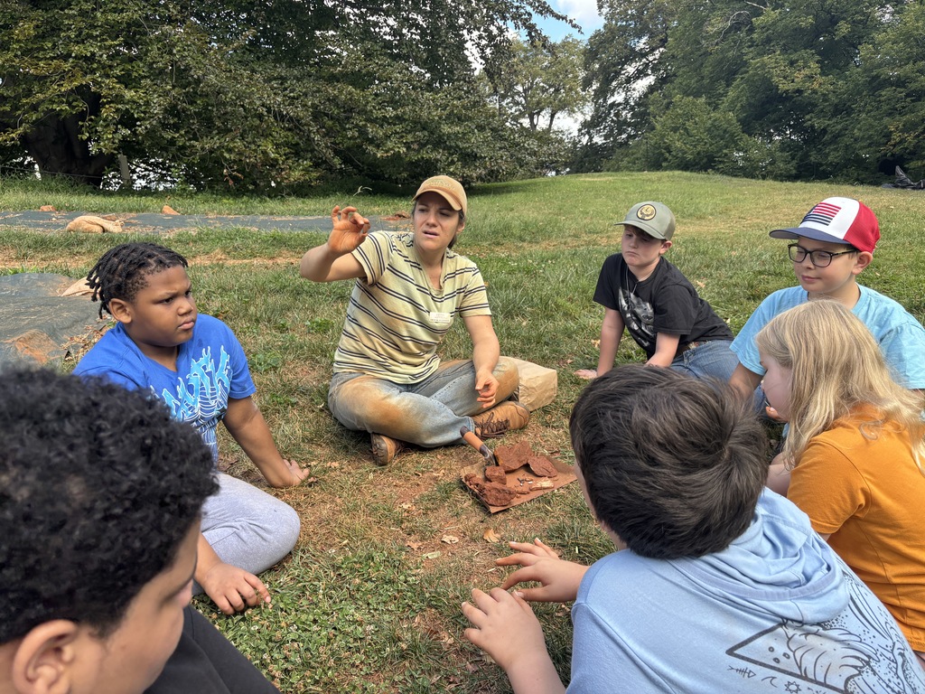 Students listening to an adult speak