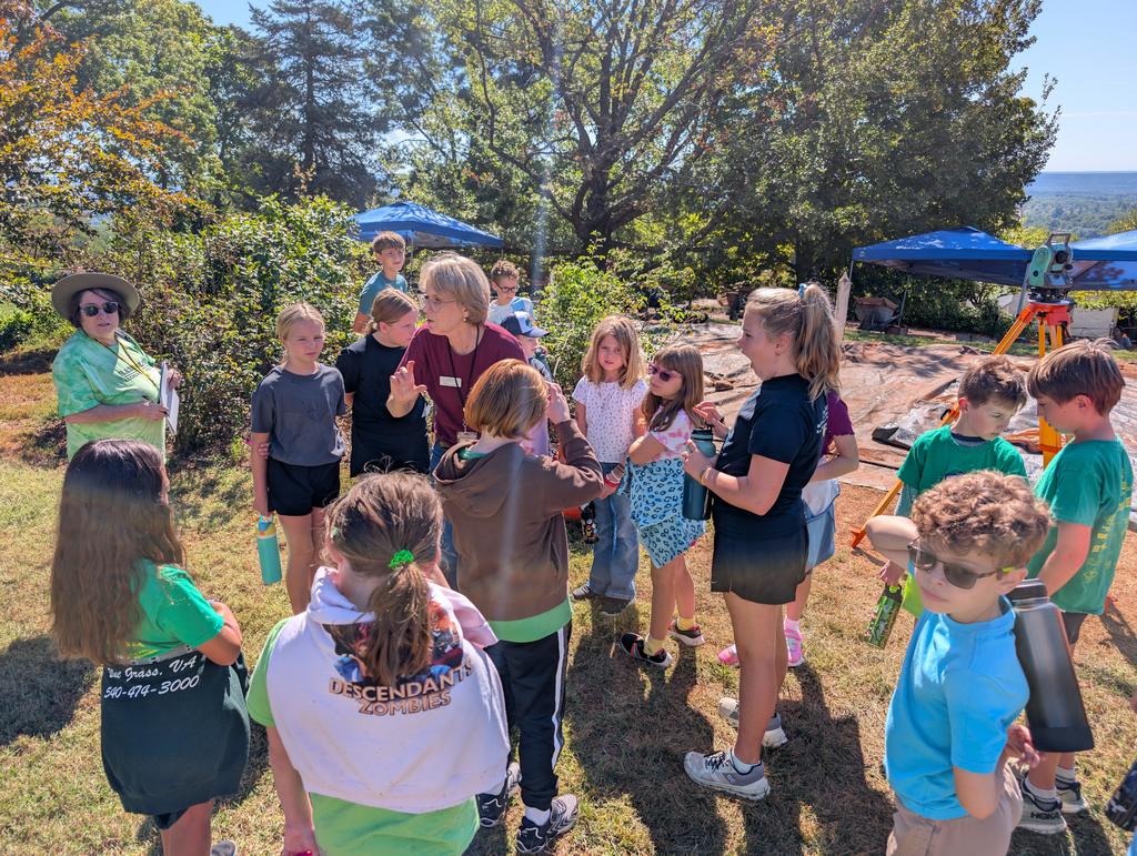Students listening to an  adult speak