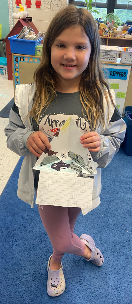 Students research animal habitats.