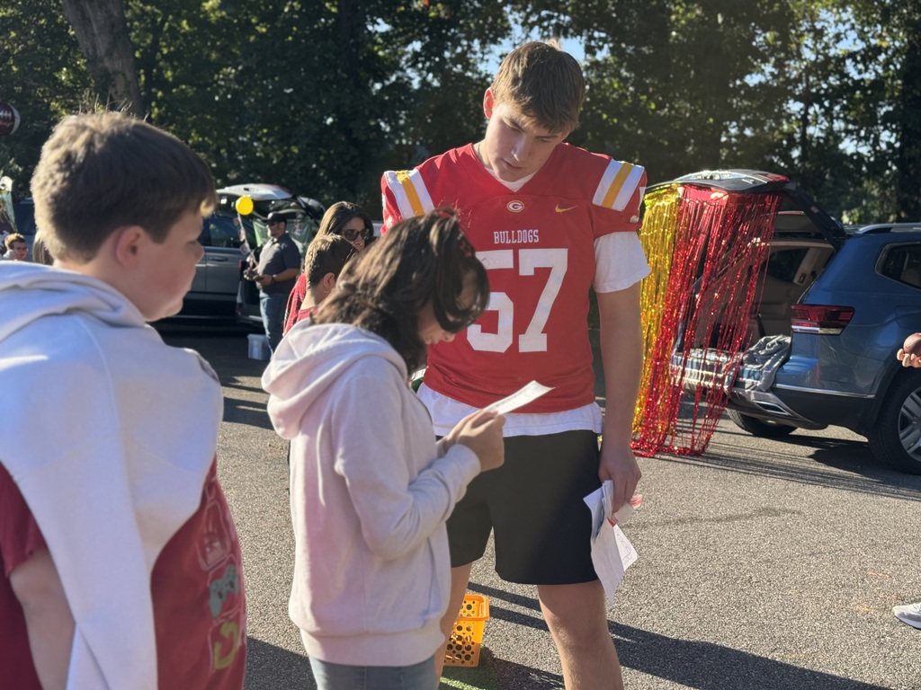 High school student helping elementary school students figure out a word problem