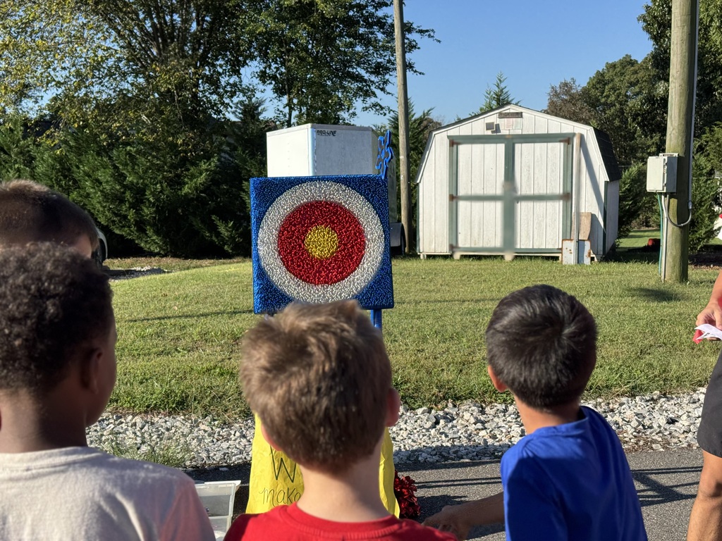 Student throwing a toy throwing star at a target
