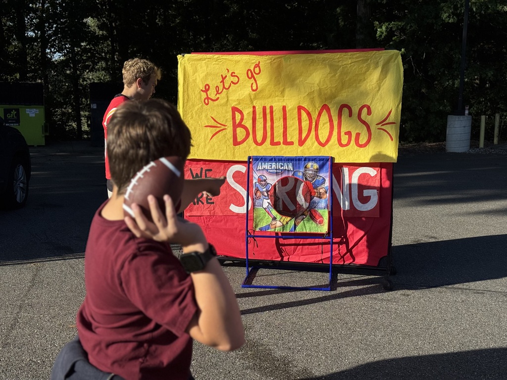 Student throwing a football at a target