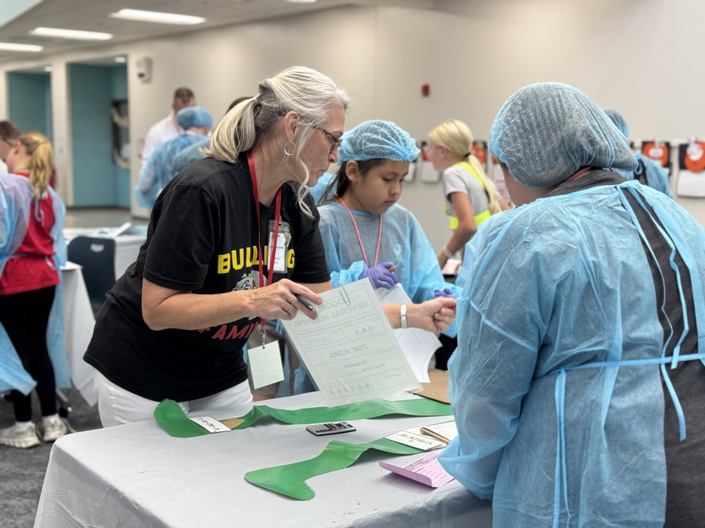 Group of students working with an adult to solve math problems