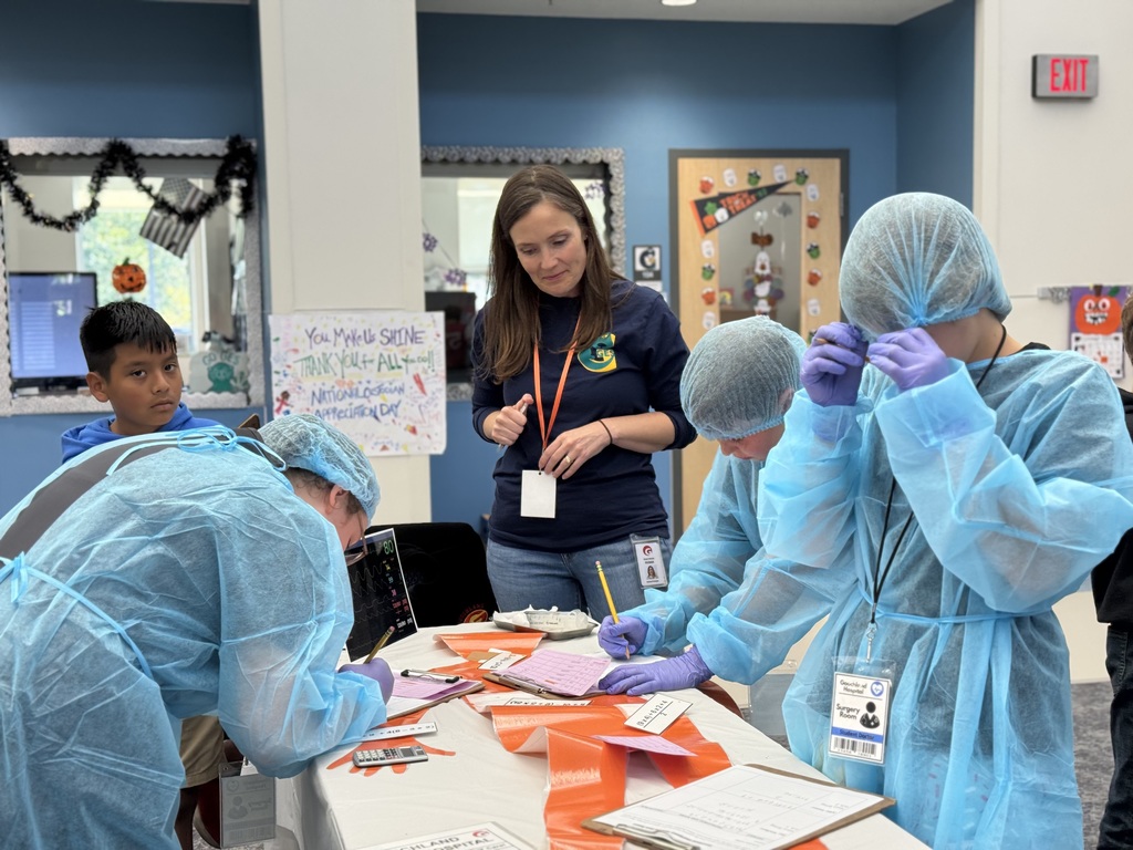 Group of students working with an adult to solve math problems