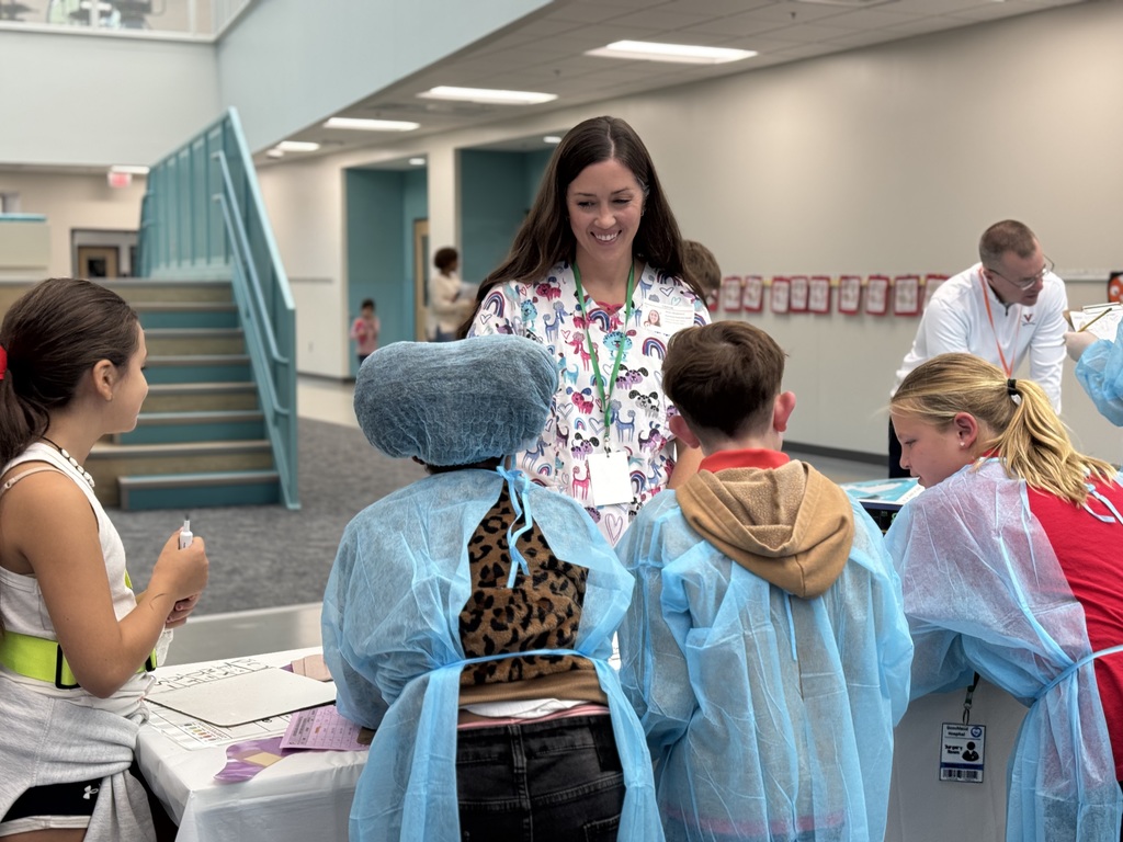 Group of students working with an adult to solve math problems