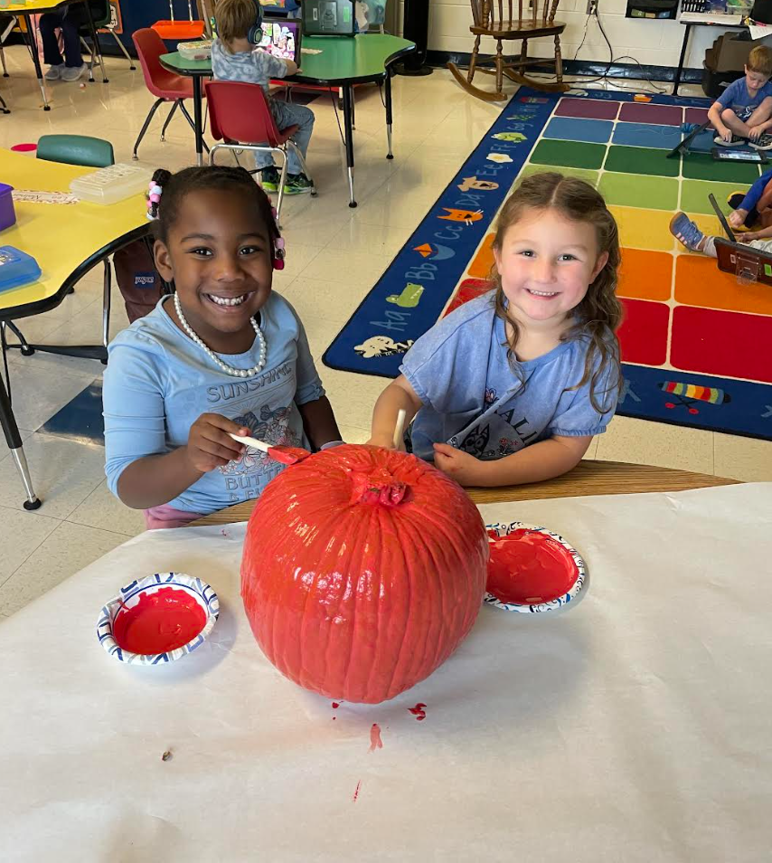 Kindergarten students preparing their pumpkin