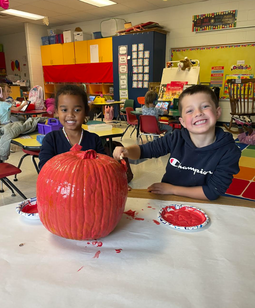 Kindergarten students preparing their pumpkin