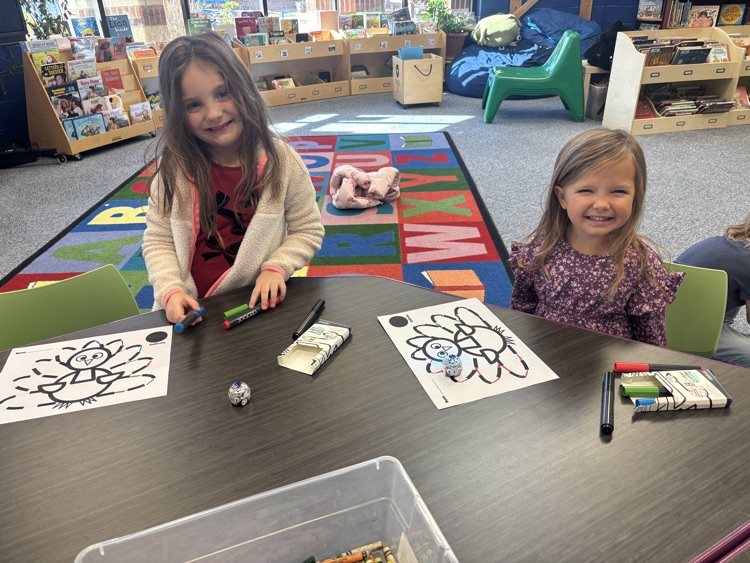Kindergartners learning how to draw lines to program Ozobots.