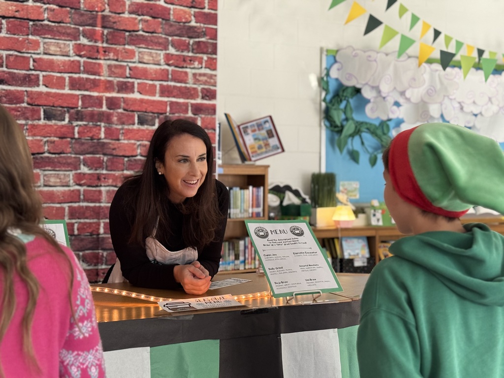 Dr. Waggener speaking to a students at Starbooks Cafe