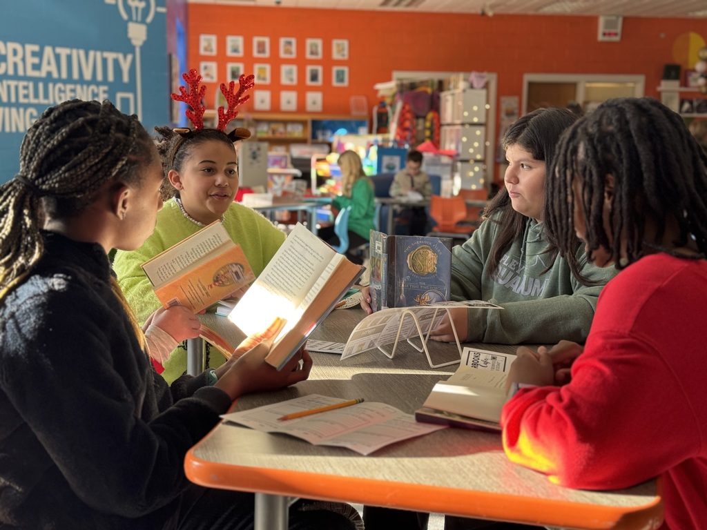 Four students discussing books 