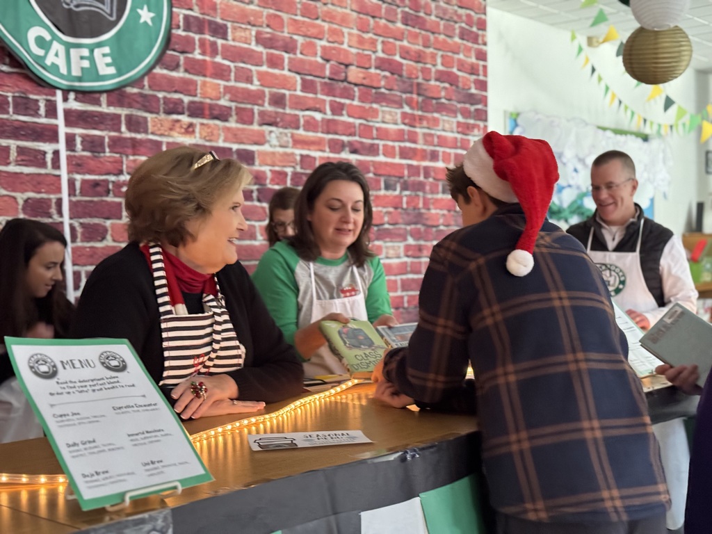 Mrs. Robinson and Mrs. Vaughan showing a student two different books