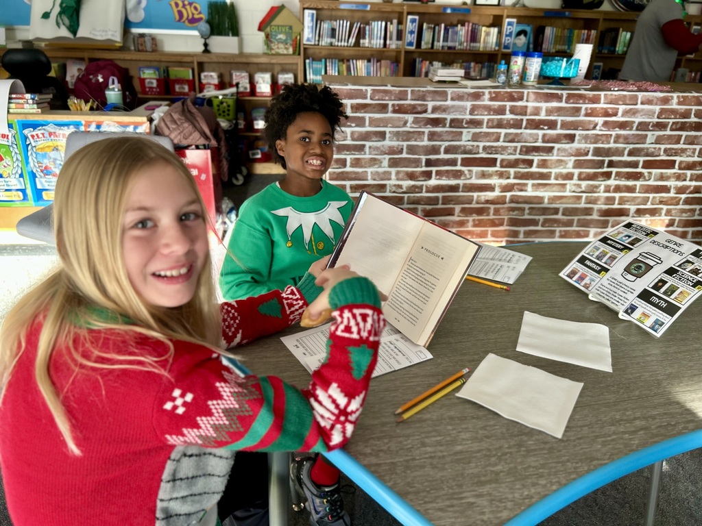 Students reading books and smiling 