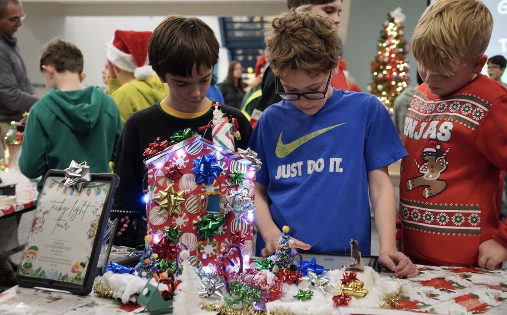 Three students working on coding their project 