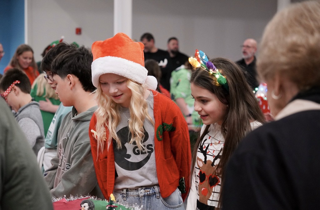 Two students smiling explaining their project 