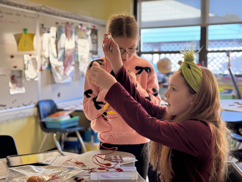 Two students exploring the Makey Makey kit