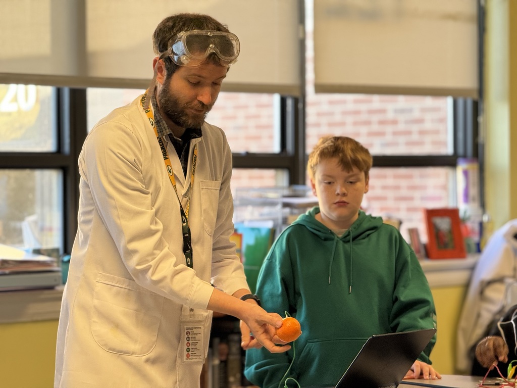 Mr. Mock showing how an orange can conduct electricity 