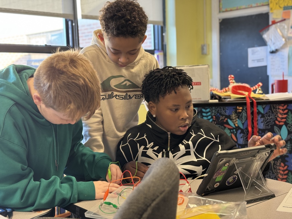 3 students engaged in testing insulators and conductors 