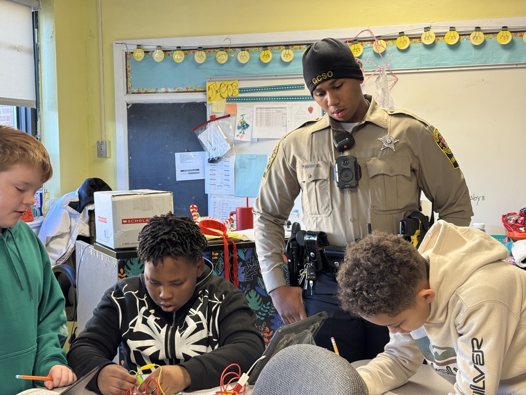 Deputy Carter watching a group of students work 